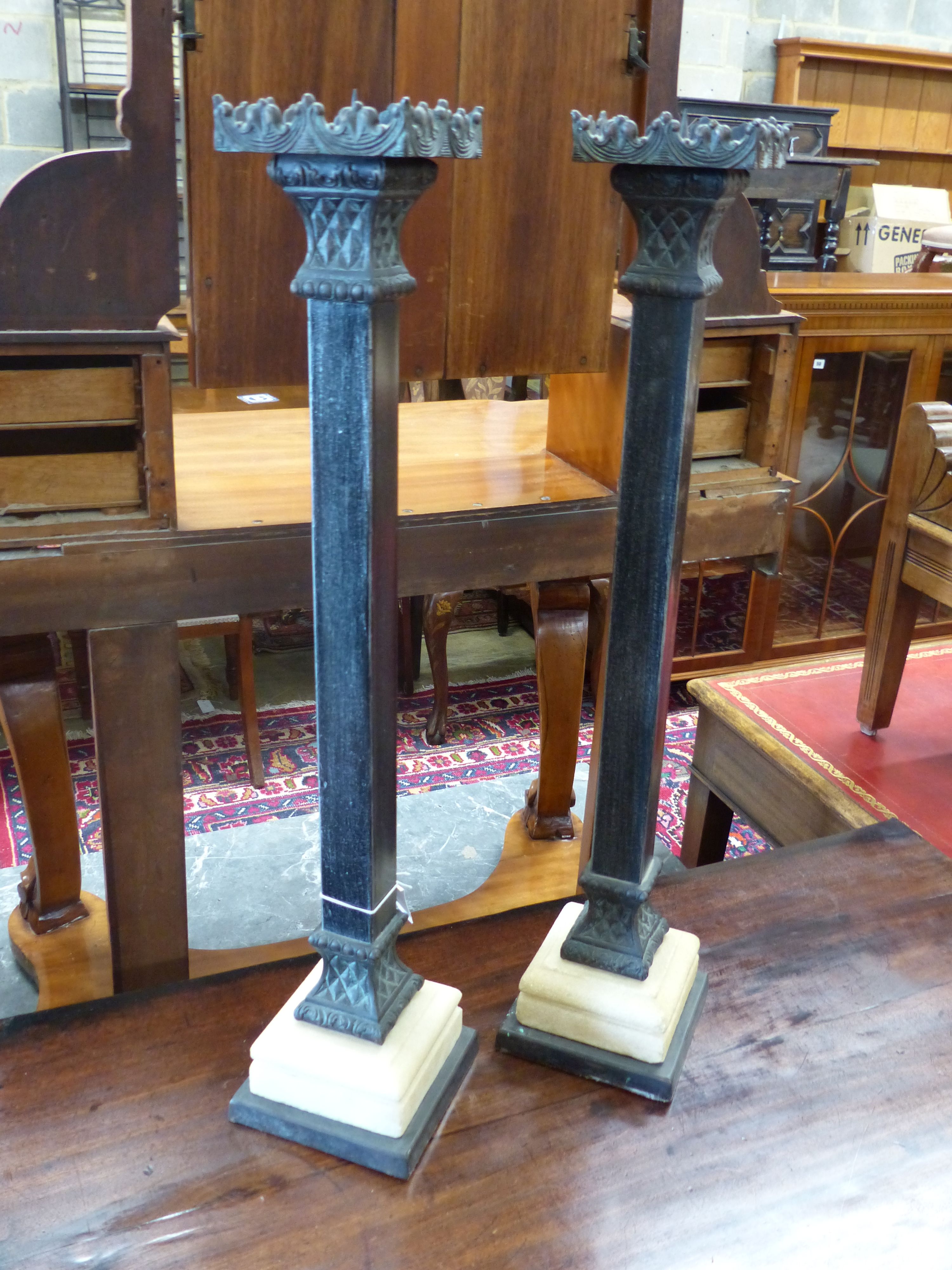 A pair of cast metal pricket candlesticks, height 67cm